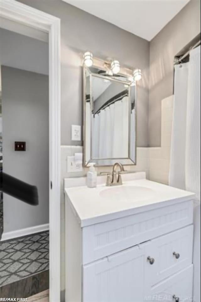 bathroom featuring vanity and curtained shower