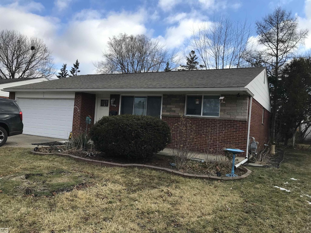 view of front of property with a garage and a front yard