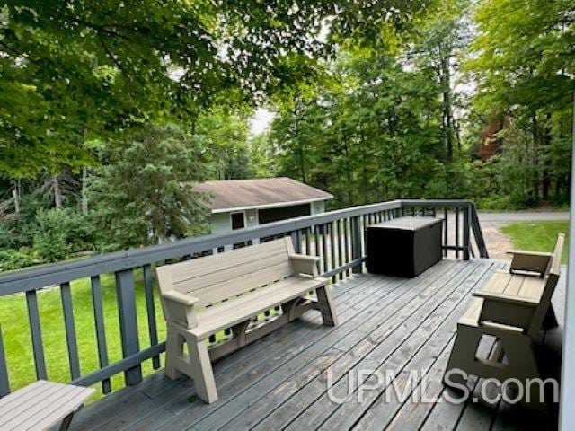 wooden terrace featuring an outbuilding