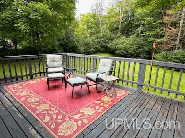 wooden terrace featuring a yard