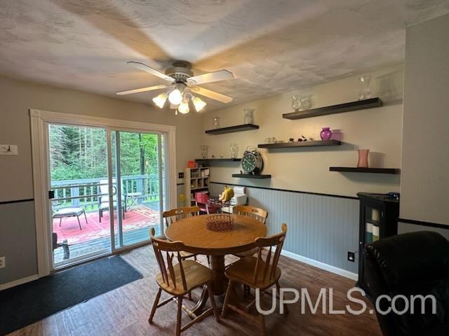 dining space with ceiling fan and dark hardwood / wood-style floors