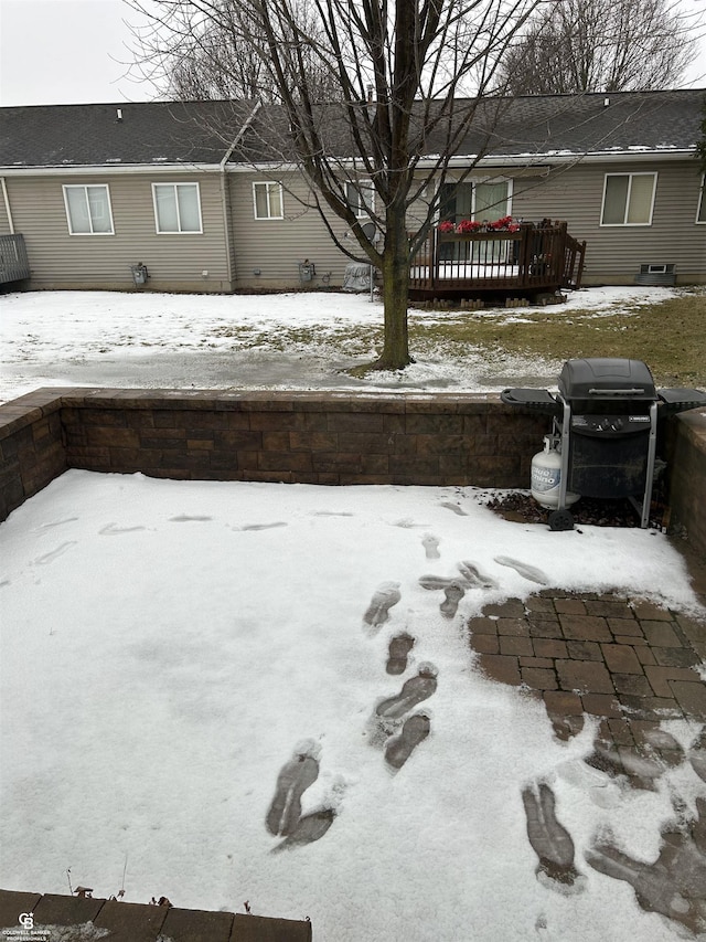 yard layered in snow featuring a wooden deck