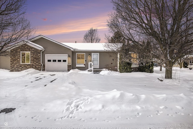 ranch-style home with an attached garage and brick siding