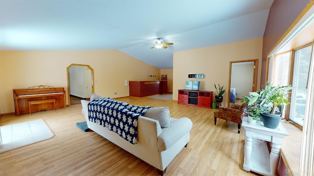 living room featuring lofted ceiling, ceiling fan, and light wood-type flooring