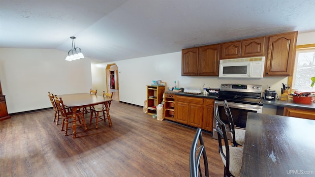 kitchen with dark wood-type flooring, decorative light fixtures, vaulted ceiling, and stainless steel electric range