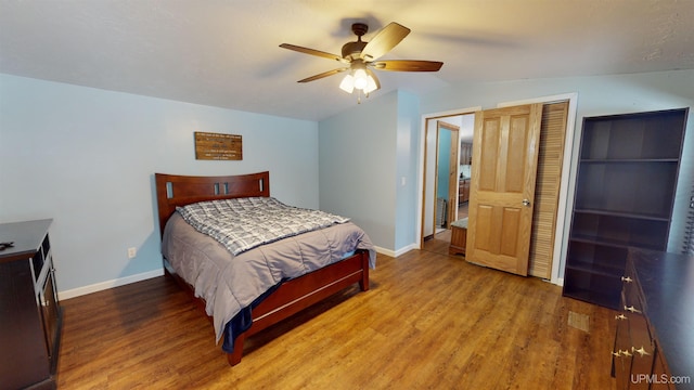 bedroom with wood-type flooring, ceiling fan, and a closet