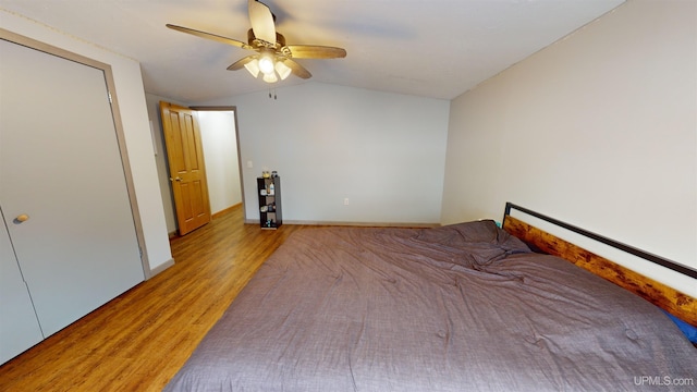 unfurnished bedroom featuring lofted ceiling, ceiling fan, and light hardwood / wood-style flooring