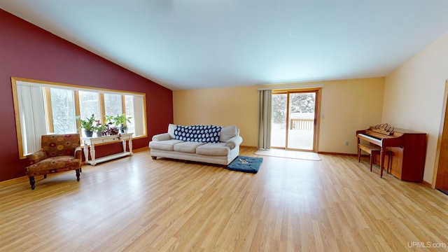 living room with lofted ceiling and light hardwood / wood-style floors