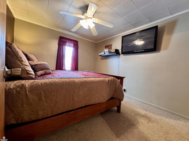 carpeted bedroom with crown molding and ceiling fan