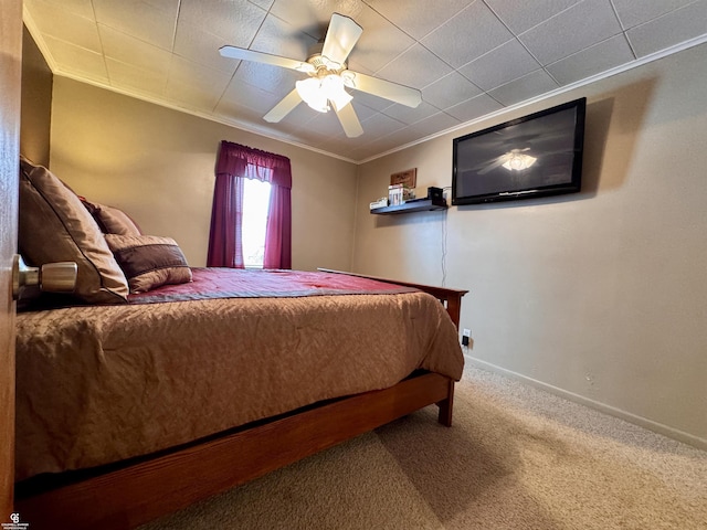 carpeted bedroom featuring crown molding and ceiling fan