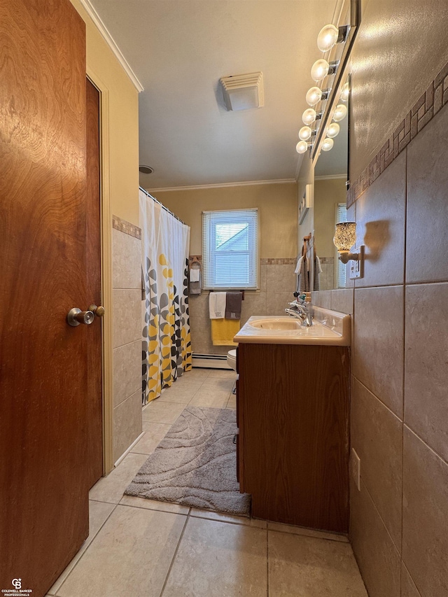 bathroom with tile patterned floors, toilet, crown molding, tile walls, and vanity