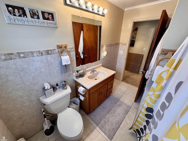 bathroom with tile walls, tile patterned flooring, vanity, toilet, and crown molding