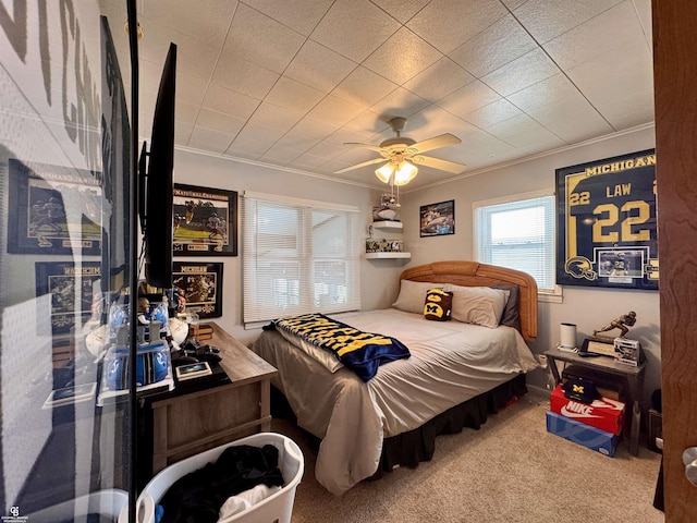 bedroom featuring crown molding, ceiling fan, and carpet flooring