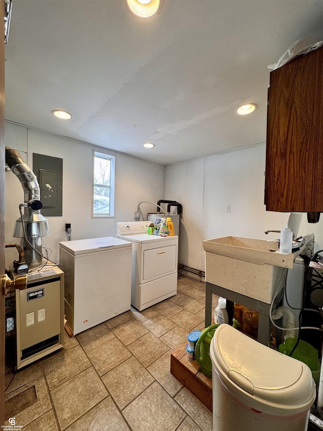 laundry room featuring separate washer and dryer, electric panel, and sink