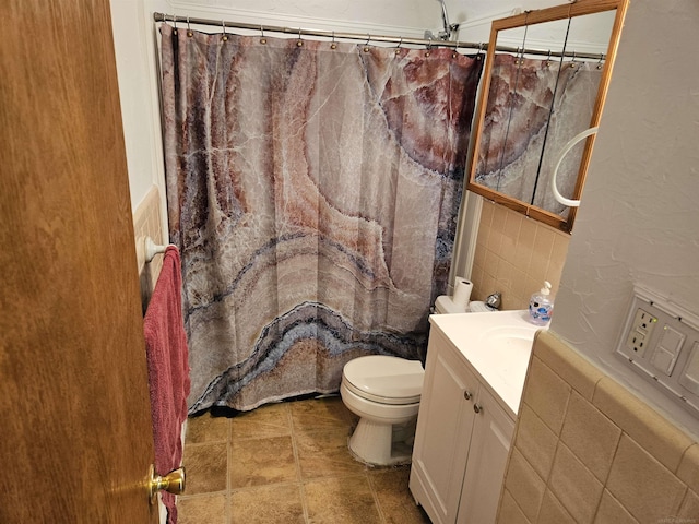 bathroom featuring a shower with curtain, vanity, tile walls, and toilet