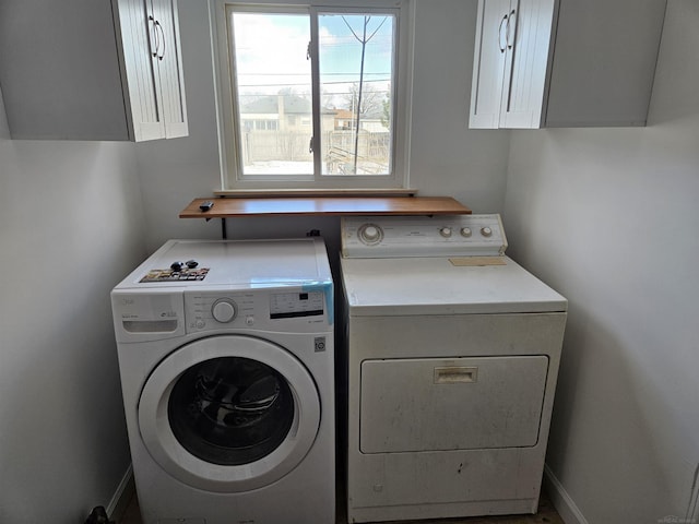 washroom featuring cabinets and washer and dryer