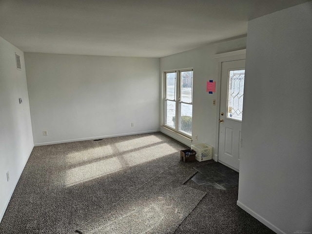 foyer entrance with dark colored carpet