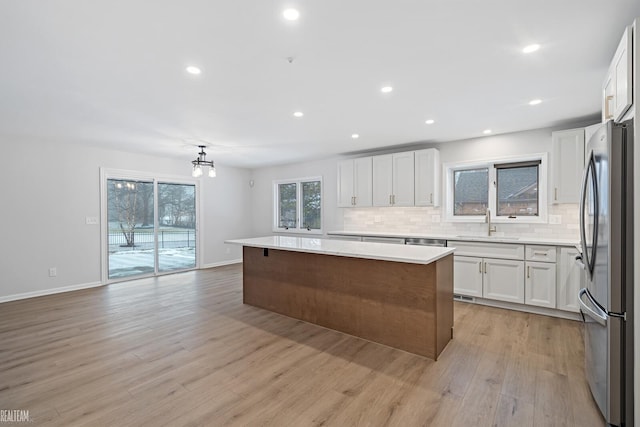 kitchen with white cabinetry and a center island