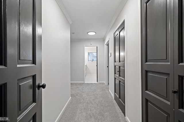 hall featuring ornamental molding and light carpet