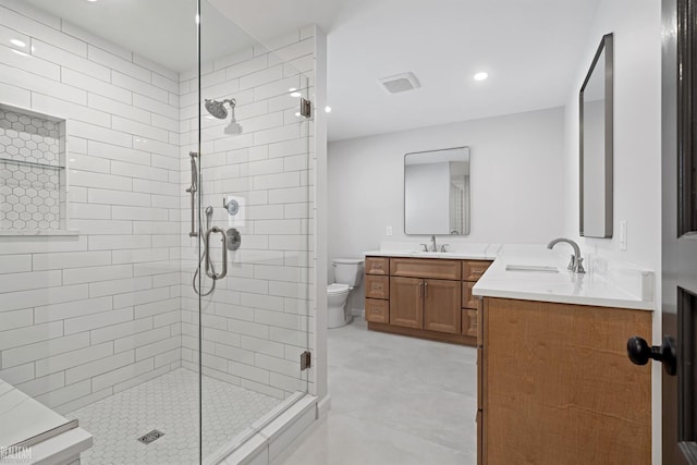 bathroom featuring walk in shower, vanity, and toilet