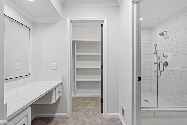 bathroom featuring vanity, ornamental molding, and tiled shower