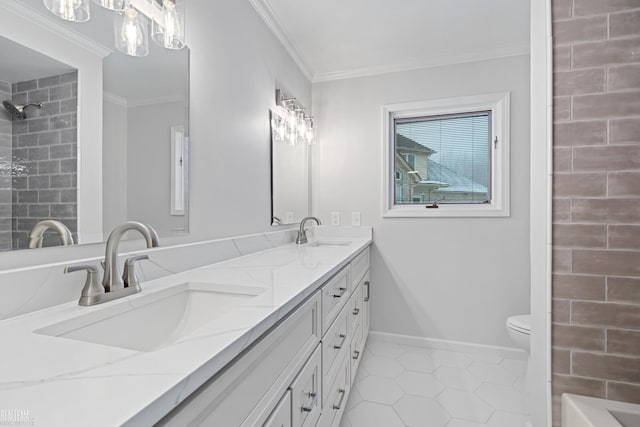 bathroom with tile patterned flooring, tiled shower, vanity, ornamental molding, and toilet