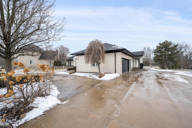 view of snowy exterior with a garage