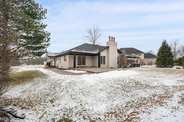 view of snow covered rear of property