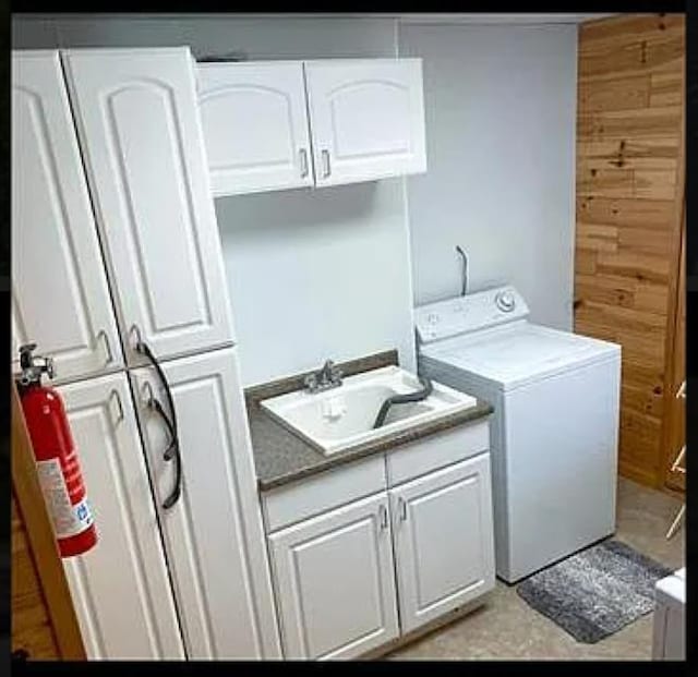 laundry area with sink, washer / dryer, and cabinets