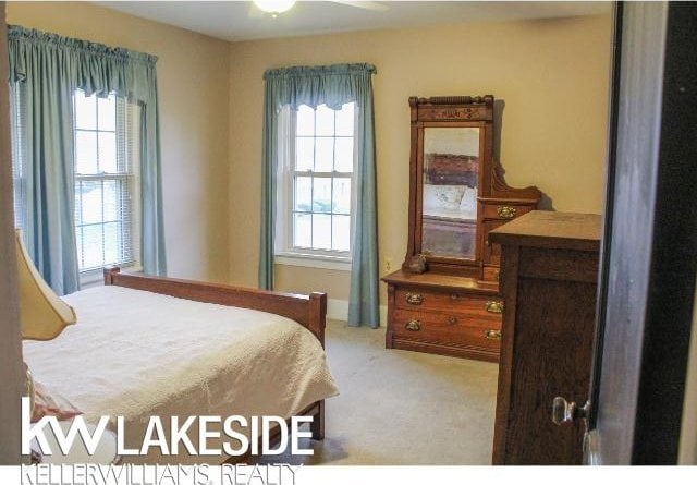 bedroom featuring light colored carpet