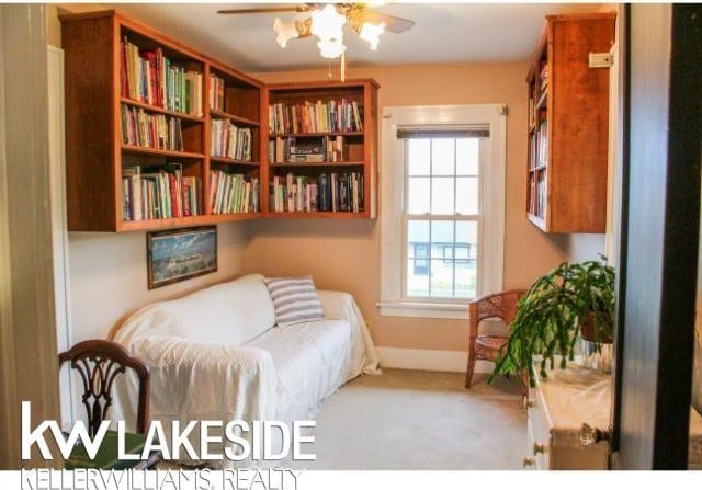 sitting room with light carpet and ceiling fan