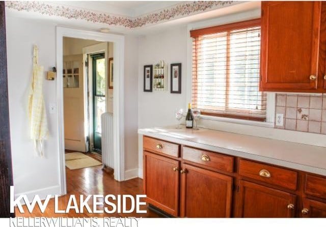 kitchen featuring dark hardwood / wood-style flooring and backsplash