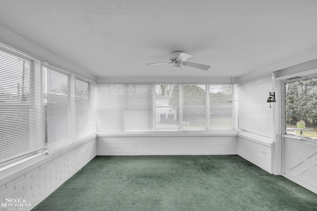 unfurnished sunroom featuring plenty of natural light and ceiling fan