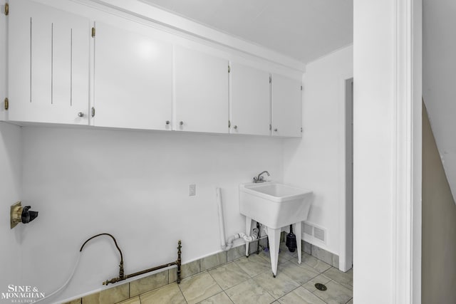 clothes washing area featuring light tile patterned floors