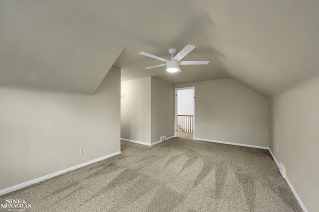 additional living space with vaulted ceiling, carpet flooring, and ceiling fan