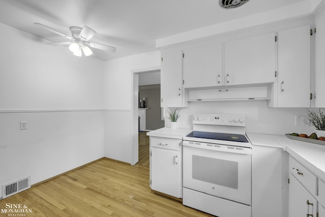 kitchen featuring white electric range, extractor fan, white cabinetry, light hardwood / wood-style flooring, and ceiling fan