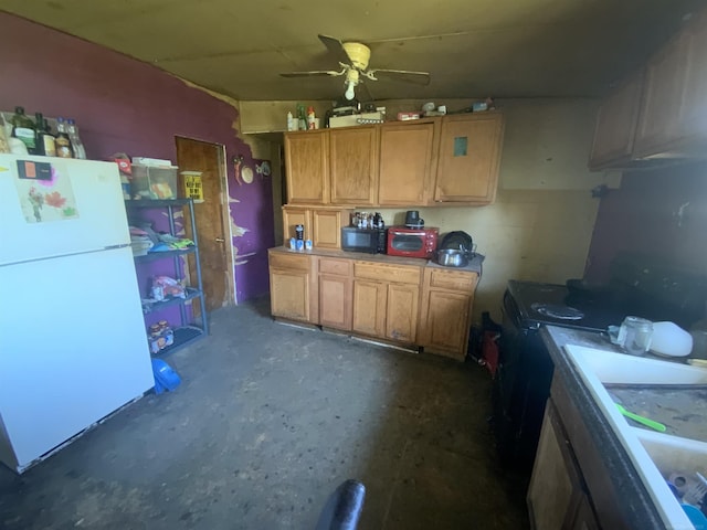 kitchen with ceiling fan, black range oven, and white fridge