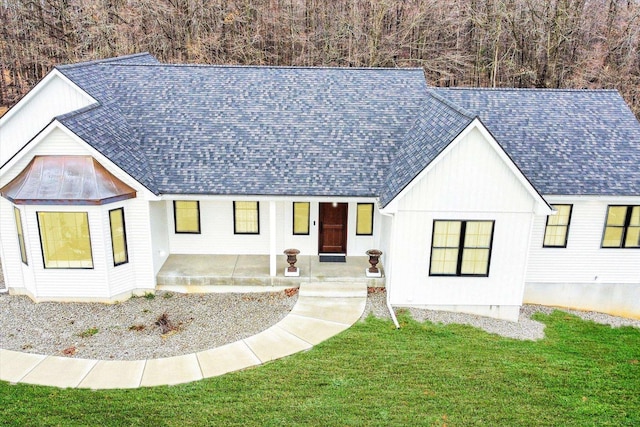 modern farmhouse style home with a patio and a front yard