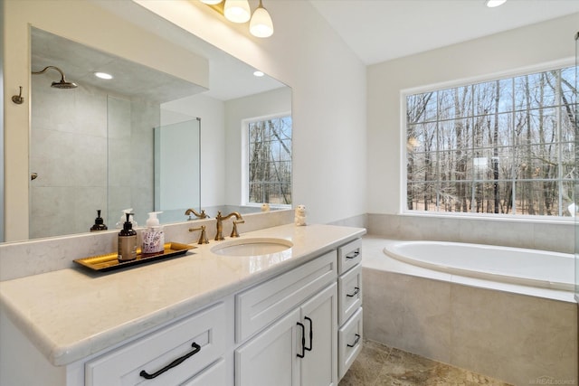 bathroom featuring vanity and plus walk in shower