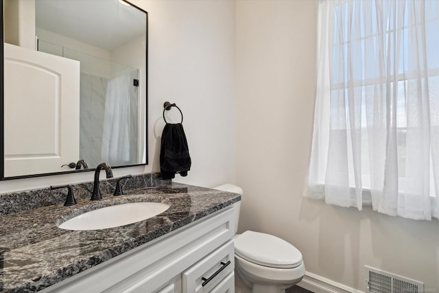 bathroom featuring vanity and toilet