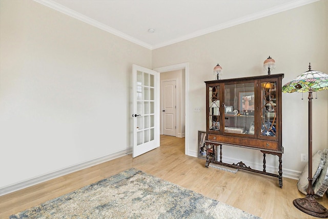 interior space with ornamental molding and hardwood / wood-style floors