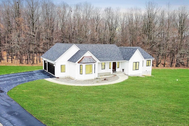 modern farmhouse with a garage and a front yard