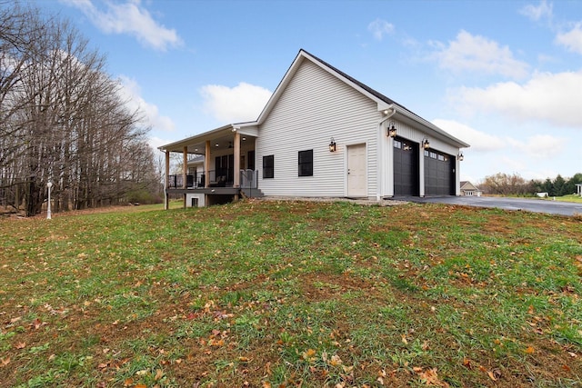 exterior space with a porch, a garage, and a yard