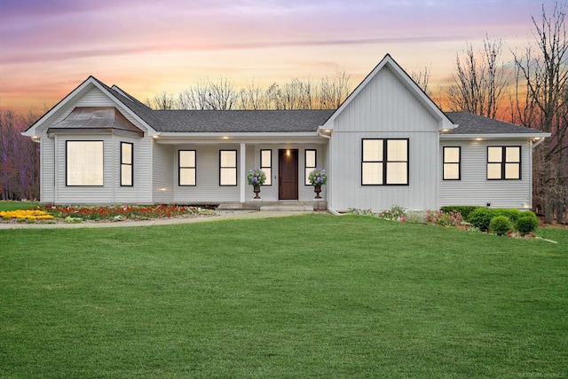 modern farmhouse featuring a lawn and covered porch