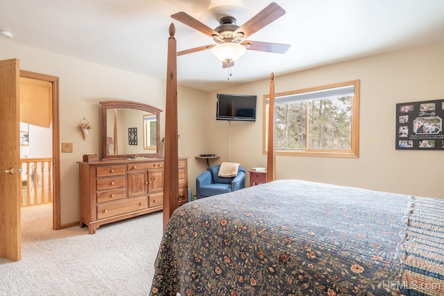 bedroom featuring light colored carpet and ceiling fan