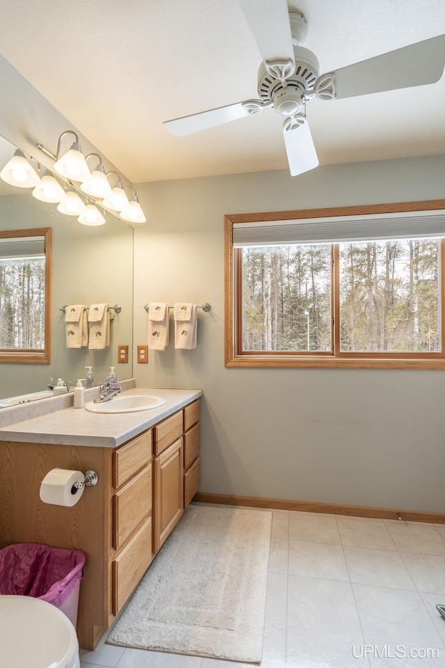 bathroom featuring ceiling fan, vanity, tile patterned flooring, and a wealth of natural light