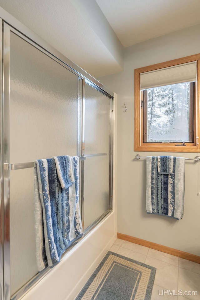 bathroom with tile patterned floors and combined bath / shower with glass door