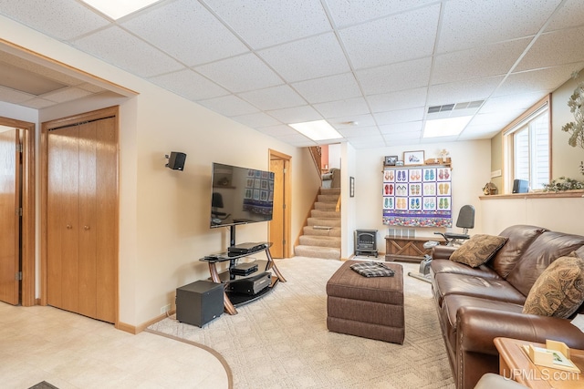 living room featuring a paneled ceiling