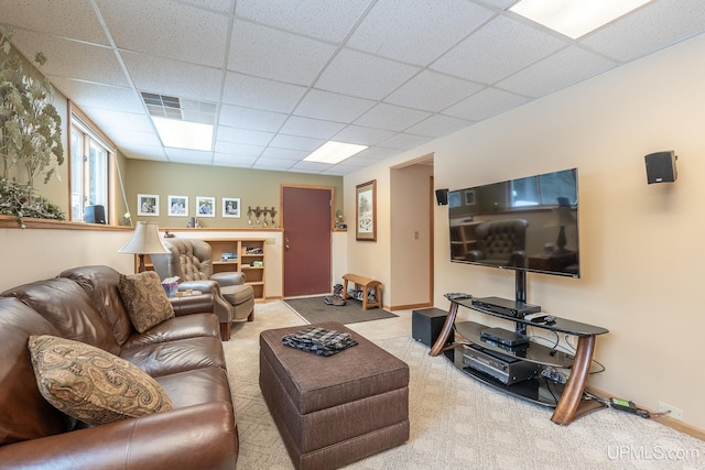 carpeted living room featuring a paneled ceiling