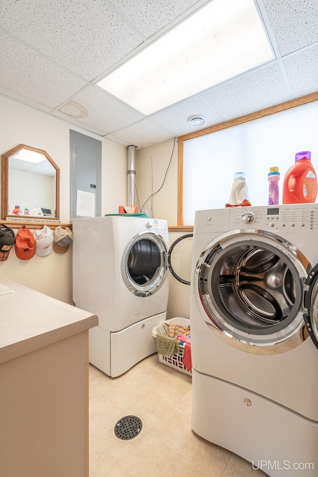 washroom with electric panel and washing machine and dryer